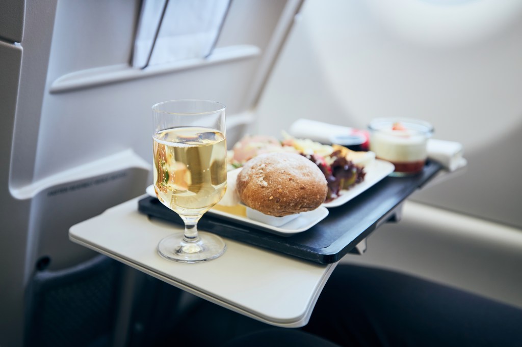 Airline food and beverages served at airplane seat tables