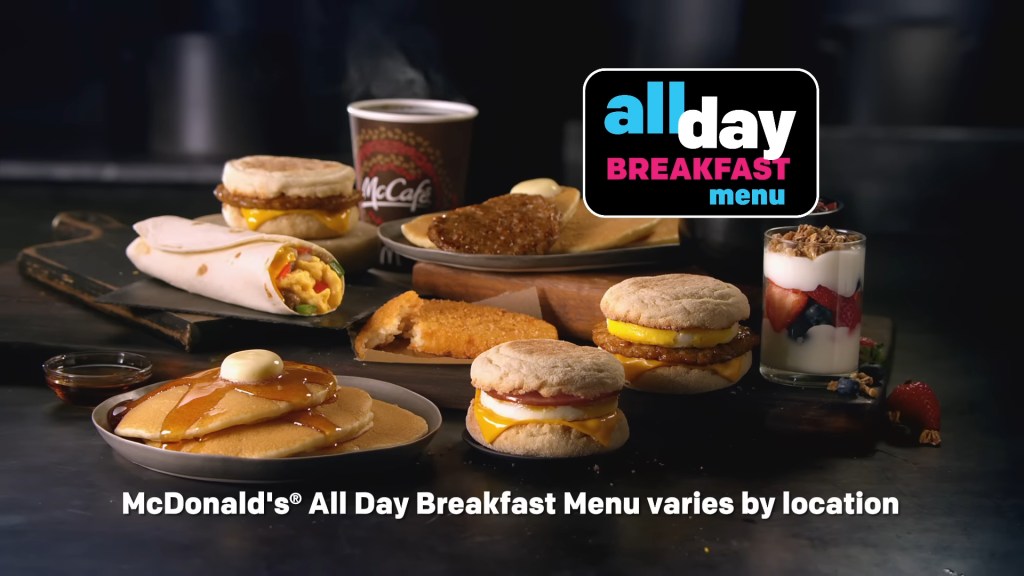 A set of sandwiches and a drink on a table, representative of the discontinued McDonald's all-day breakfast